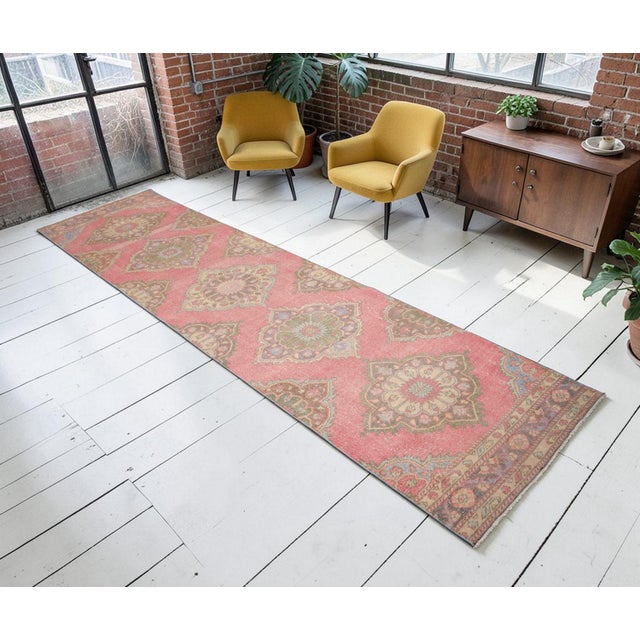 Woven in the famed workshops of Oushak during the 1960s, this authentic Anatolian runner carries a beautiful narrative of...