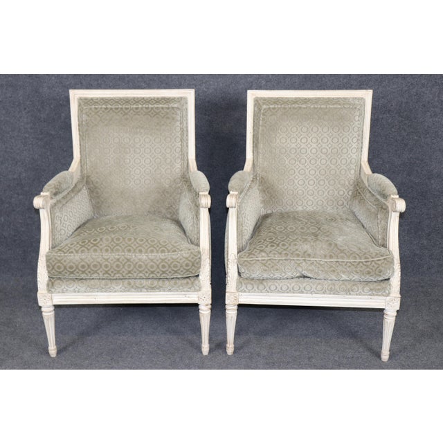 Add elegance to interior with this exquisite pair of French Bergère chairs, masterfully crafted in the Louis XVI style....