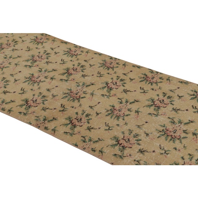 This vintage runner rug is a 3x8 Turkish distressed piece, made with hand-knotted wool circa mid-20th century. It is an...