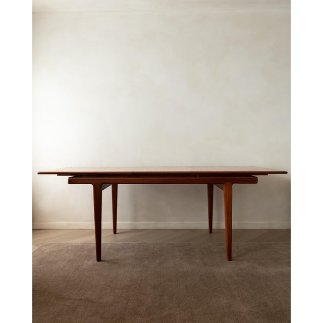 A vintage danish modern teak extendable dining table attributed to sven ellekaer, produced in denmark during the 1960s....