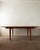 A vintage danish modern teak extendable dining table attributed to sven ellekaer, produced in denmark during the 1960s....