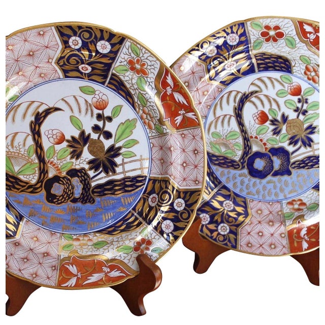 A pair of early 19th century, ca. 1810 - 1820, English Imari dinner plates exquisitely decorated in a fresh palette of...