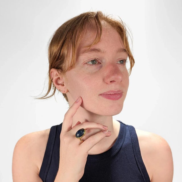 A very fine 18k gold and lapis cocktail ring by designer Erwin Pearl. The asymmetrical ring features an oval lapis lazuli...