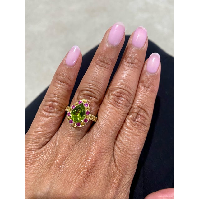 3.16 Carat Peridot Sapphire Yellow Gold Engagement Ring This beautiful ring has a Pear Cut Peridot in the center that...