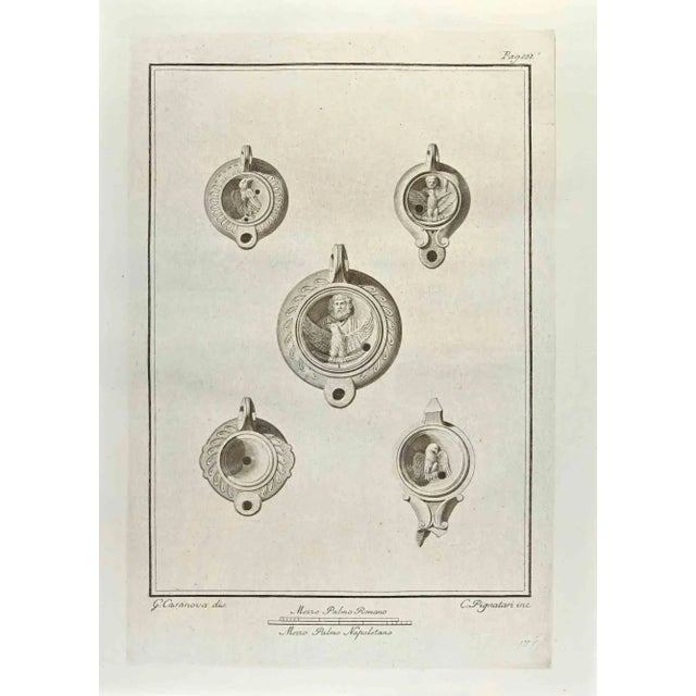 Jupiter and Sacred Eagle On Oil Lamp from "Antiquities of Herculaneum" is an etching on paper realized by Carlo Pignatari...
