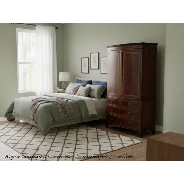 Full of authentic charm and character, this rare and impressive bow-front mahogany linen press dates to the first half of...