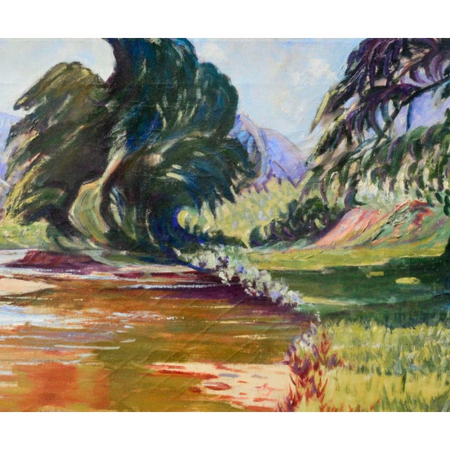 Vibrant landscape of a calm river with colorful reflections winding through a lush valley of grasses and trees, with blue...