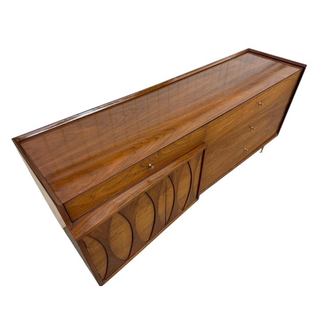 Stunning 1960’s Mid-Century Modern walnut Catseye dresser, a true statement piece for any vintage-inspired interior. This...