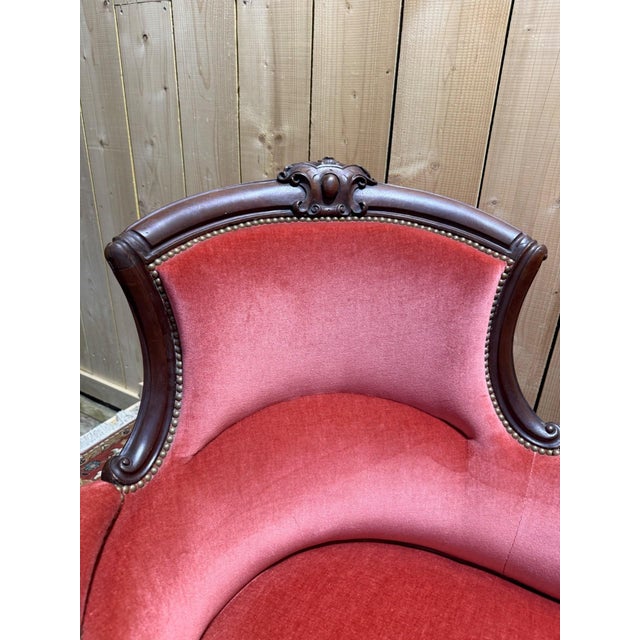 A two-seater louis-philippe style loveseat, napoleon iii period, circa 1850-1870, in solid dark brown stained mahogany....