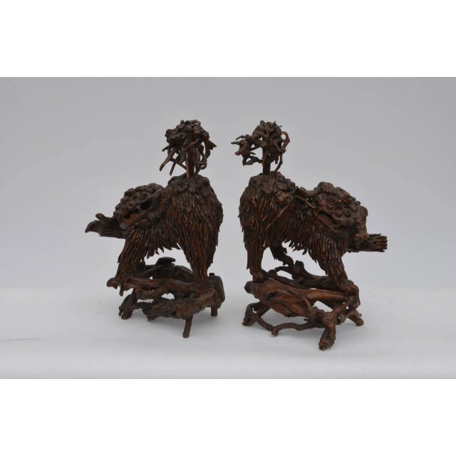 Pair of rare Chinese carved wood foo dogs. Perfect for the etagere in your home.