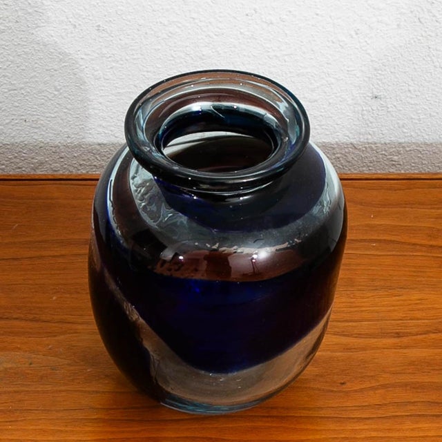 Unique hand blown glass vase Circa 1970. It comes in dark blue color with unique clear glass designed throughout.