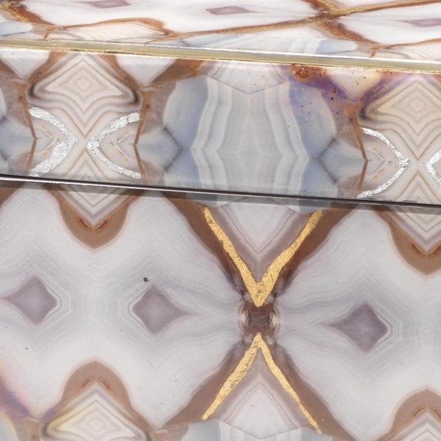 The design on this box is taken from photos of agate repeated in a way that gives the impression of looking through a...