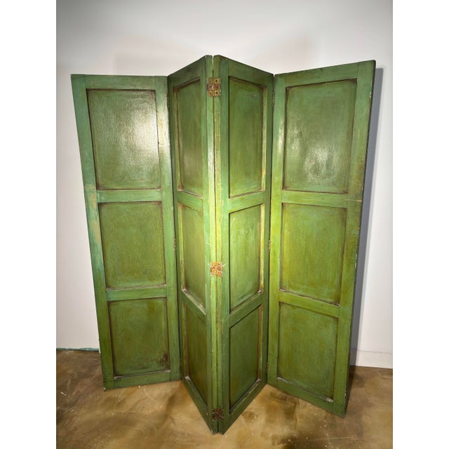 An exceptional and rare four-panel screen featuring an Arte Povera (or Lacca Povera) design on an antique green lacquer...