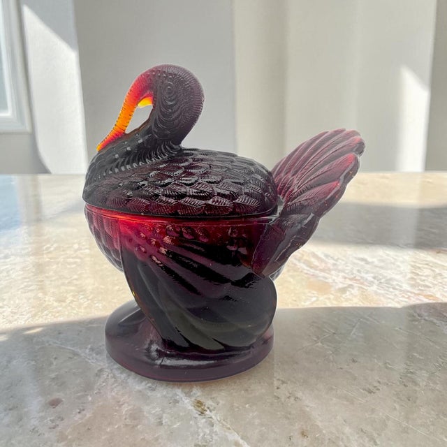 A Mid-Century Modern figural candy dish in ruby red Amberina glass attributed to L.E. Smith, modeled as a stylized turkey...