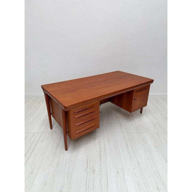 Elegant vintage executive desk designed by ib kofod-larsen and crafted in teak. The design combines clean scandinavian...