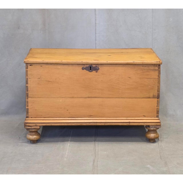 A lovely antique early 1900s rustic German natural pine blanket chest that stands on distinctive oversized turnip feet...