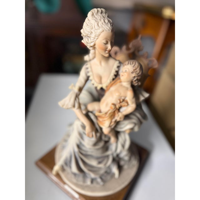 Beautiful Lady with Child by Guisseppe Armani. I purchased in Italy during my travels.