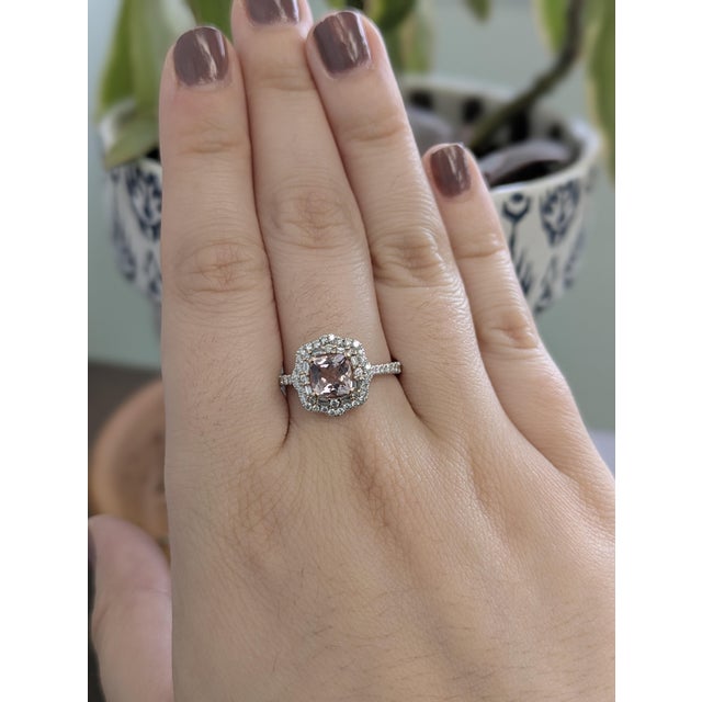 Capture hearts with this exquisite 0.8-carat Cor de Rosa morganite ring, showcasing a delicate peach-pink gemstone...