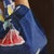 The painting features a young girl adorned in a traditional kimono, her expression contemplative and serene. The...