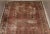 Distressed antique Persian rug in floral style. Rust/pink field within blue border. 10'8"x 14'