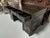 Asian black lacquer writing desk featuring extensive hand-decorated gilt ornamentation throughout. The rectangular top is...