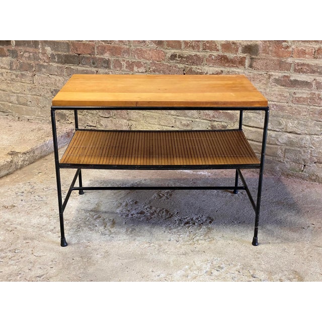 Planner Group side table designed by Paul McCobb for Winchendon. Circa 1955. Featuring a birch top, iron frame and split...