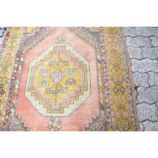 This is a vintage Turkish Oushak rug from the 1960s. The piece was hand-knotted.