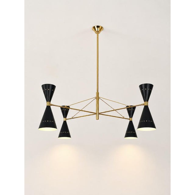 Elegant vintage chandelier featuring four entirely brass axes with a perforated double-cone lampshade in burnished iron,...
