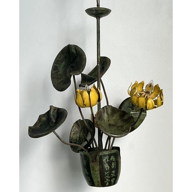 This extraordinary vintage chandelier, attributed to the artisanal work of Garland Faulkner, is a masterful blend of...