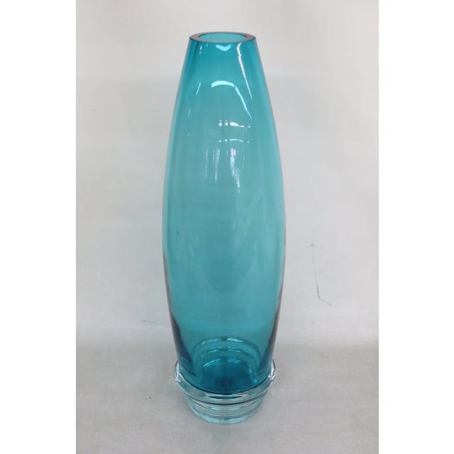 This magnificent Vase has classic Mid Century style with an impressive tall silhouette and a lovely blue color. We believe...