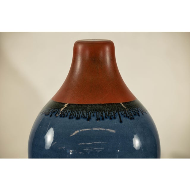 This pair of contemporary artisan-crafted ceramic vases offers a striking combination of bold color and meticulous...