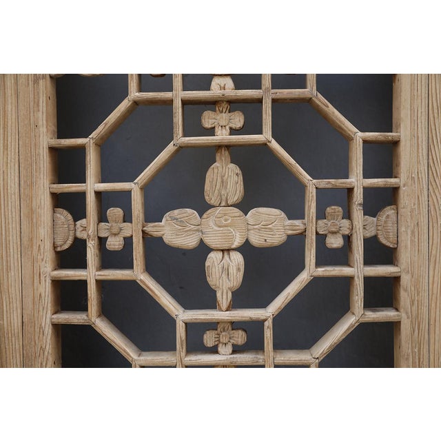 A cohesive set of antique Chinese panels featuring crisp geometric detailed (yin/yang) latticework below carved botanical...