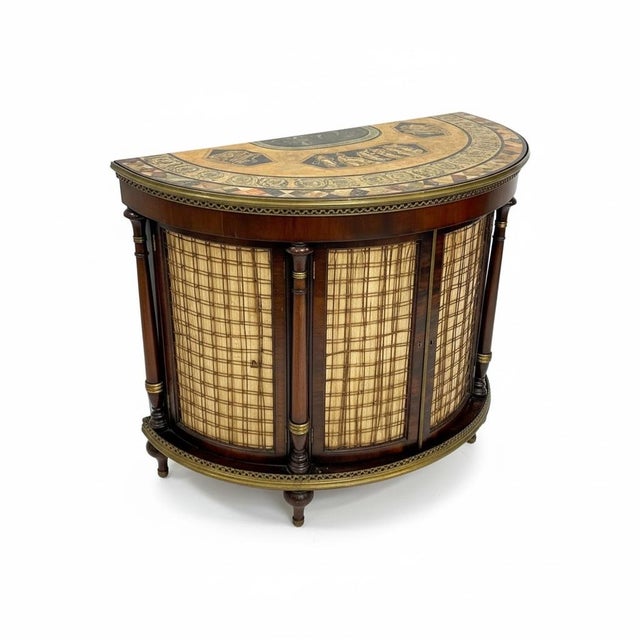 This is a 1940s/50s Italian regency Pietra Dura style painted flame mahogany demilune cabinet. It has a nice brass gallery...