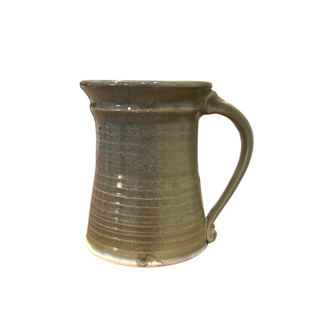 A lovely, vintage studio pottery mug. Features a handmade, stoneware mug in a rustic, green glaze. Unsigned.
