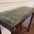 Bombay Co. Neoclassical inspired empire style foyer console table. Features a green marble top, Mahogany wood with brass...