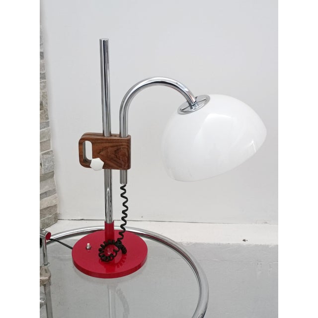 Magnificent designer table lamp by Pinokio. Spain, 1970s. Red lacquered metal base. The structure is chromed metal with a...