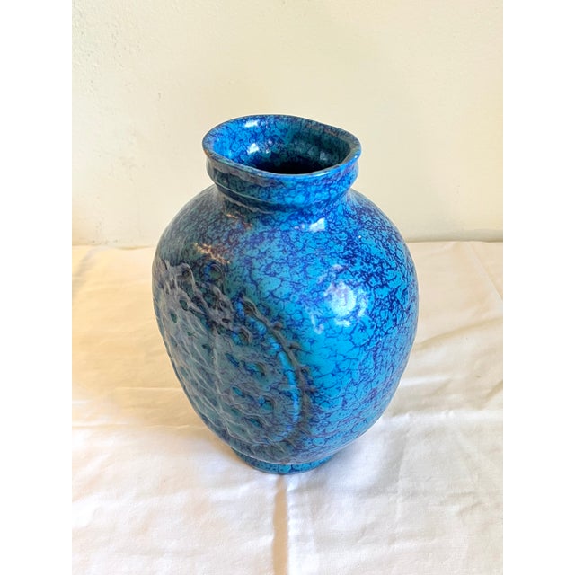 This vintage studio pottery vase/ water jug has a stunning mottled blue effect . It's the perfect anchor to floral...