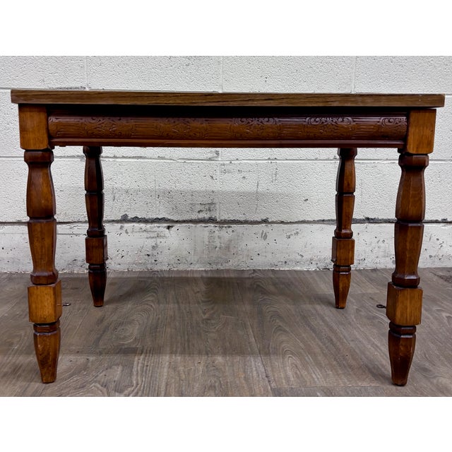 This is a gorgeous vintage Jacobean Revival style coffee table, side table, or end table featuring a wood-grain laminate...