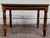This is a gorgeous vintage Jacobean Revival style coffee table, side table, or end table featuring a wood-grain laminate...