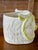 A charming vintage sculptural ceramic owl planter or cachepot finished in glossy white with hand-applied lime green...