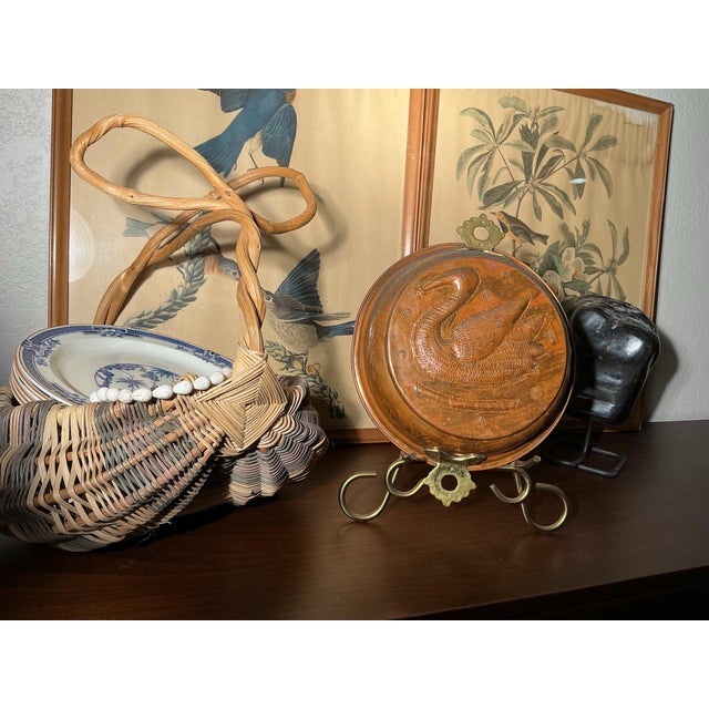 An antique copper mold featuring an elegant swan in deeply sculpted relief, distinguished by its generous scale, hand-...