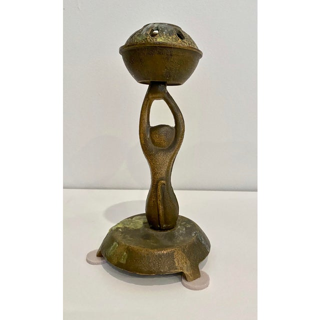 Vintage bronze/brass Japanese candleholder. It's shaped in such a whimsical way that one side of the candleholder...