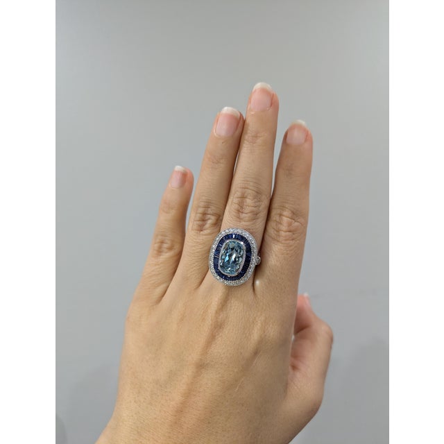 This exquisite ring is a stunning addition to any jewelry collection. Featuring a captivating 5.3 carat Aquamarine as its...