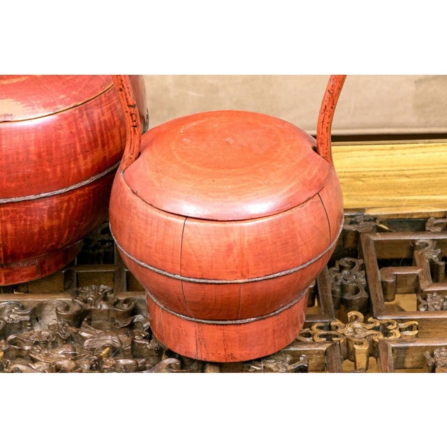 A lovely pair of complimentary antique Chinese red lacquer covered baskets made with individual panels cut by hand and...