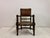 An Arts and Crafts oak armchair dating from the early 20th century, constructed in solid oak with strong architectural...