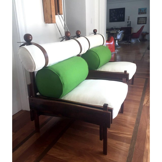 A pair of vintage rosewood lounge chairs designed by Sergio Rodrigues, made by Oca for Meia Pateca in Brazil, circa 1963....