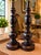 Elegant pair of tall table lamps with a traditional turned wood-look design and rich dark finish. The beautifully shaped...