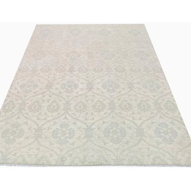 ACTUAL SIZE: 8’10” x 12’2″ PRIMARY COLOR: Cream / Light Blue AGE: New ORIGIN: Pakistan MATERIALS: Wool FOUNDATION: Cotton...