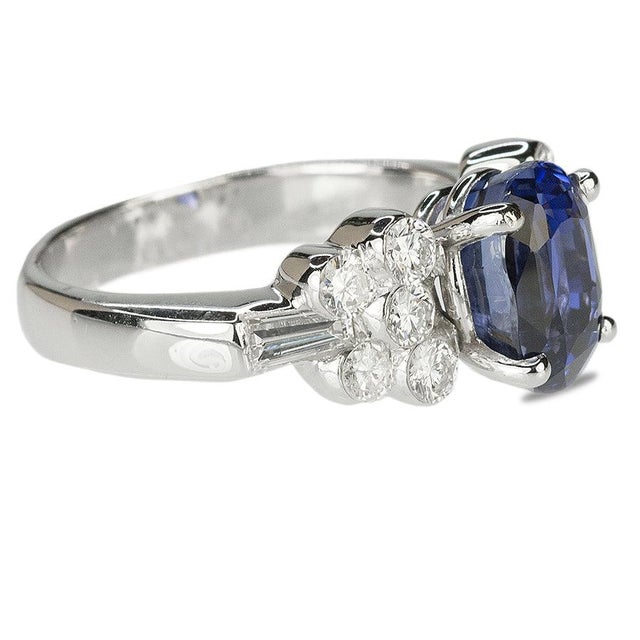 18k Ring set with 1 AGL certified 3.47 carat No Heat Ceylon sapphire and 0.85 carats of round diamonds. 6.35 grams Size...