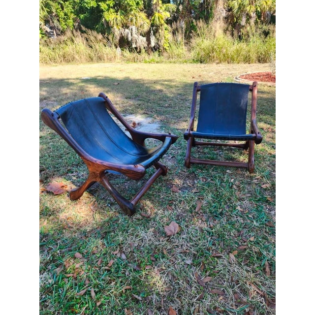 pair of 1960s Don Shoemaker Sloucher lounge chairs, in solid cocobolo rosewood and black leather. Iconic example of...